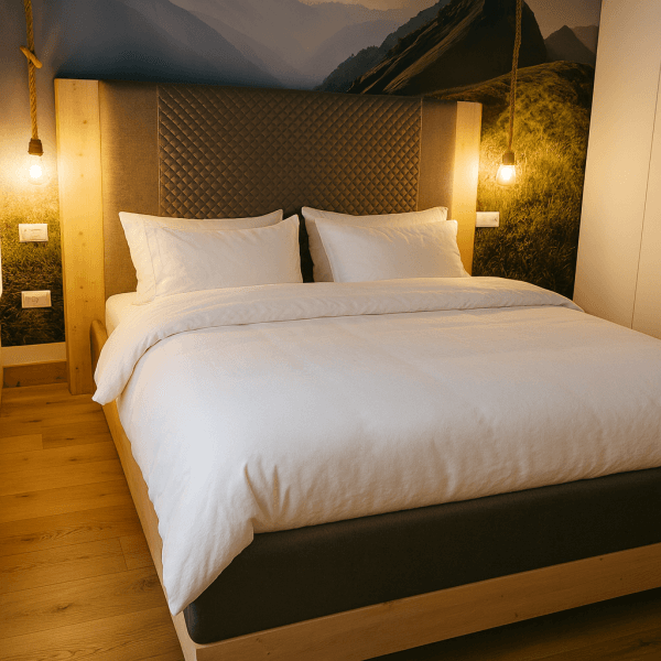 Modern bed with a wooden frame and plush headboard in a well-lit room.